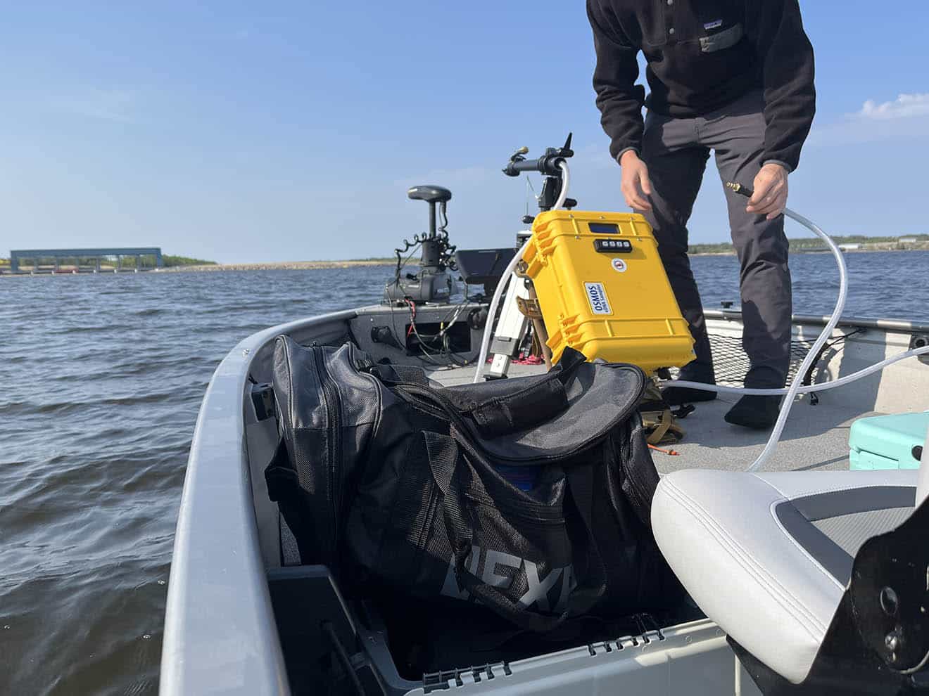 A person is working at the front of a boat.